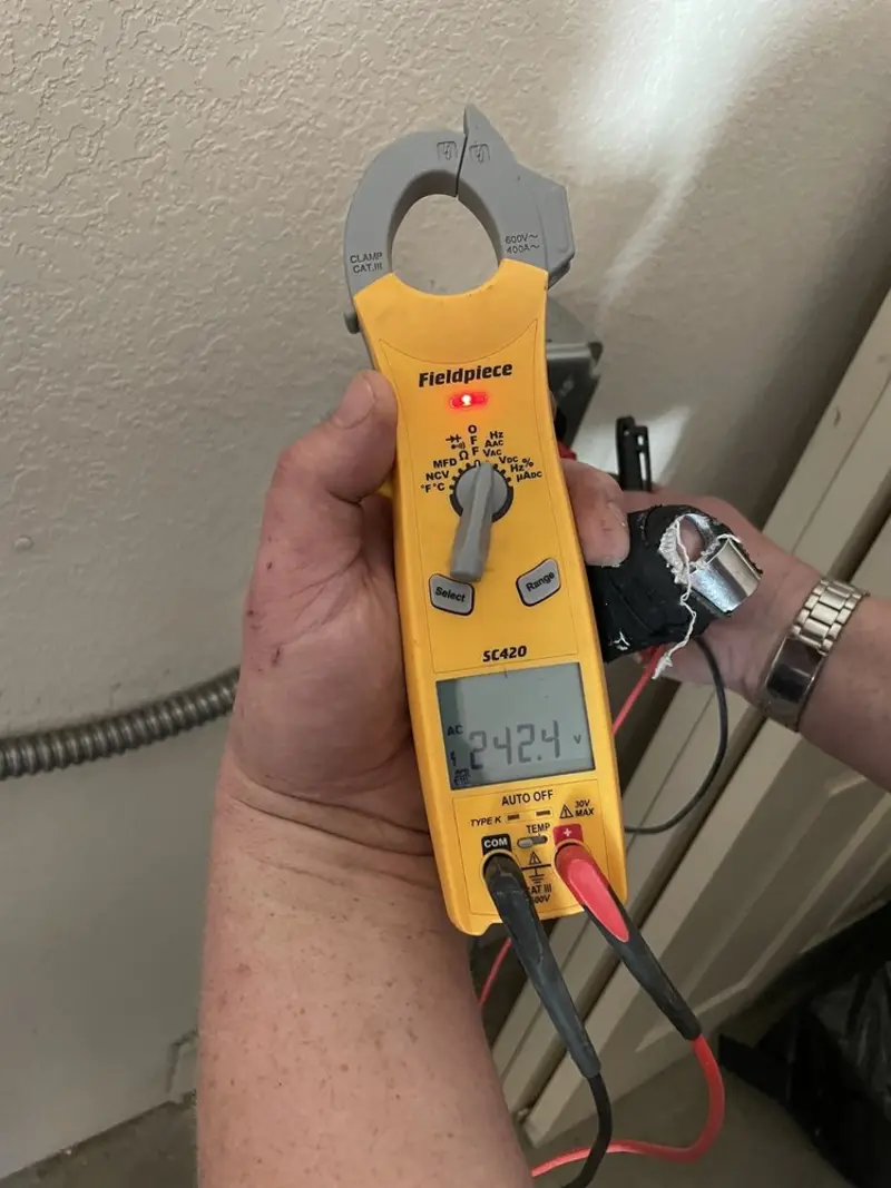 Voltage testing with clamp meter during Ceiling Fan Installation in Armagh